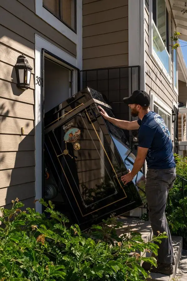 Boswell safe mover guiding a large gun safe through a residential doorway